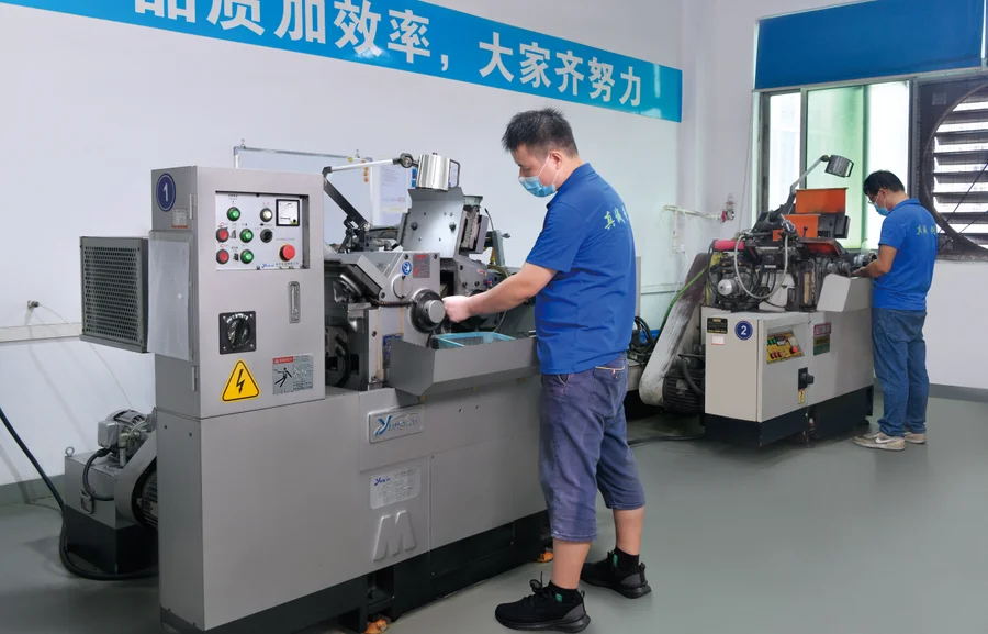 Operator working at precision grinding equipment in the workshop