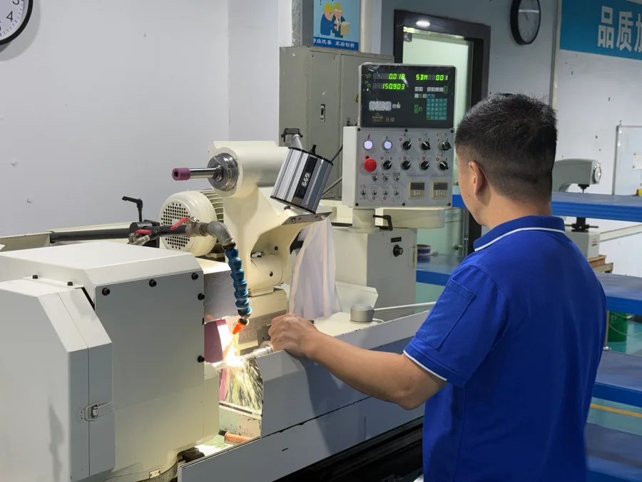 Operator working at a surface grinding machine with sparks at the wheel