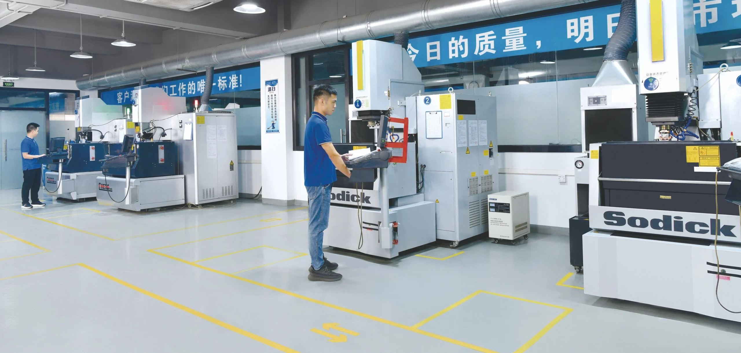 Operators and SODICK EDM equipment in an existing workshop photograph