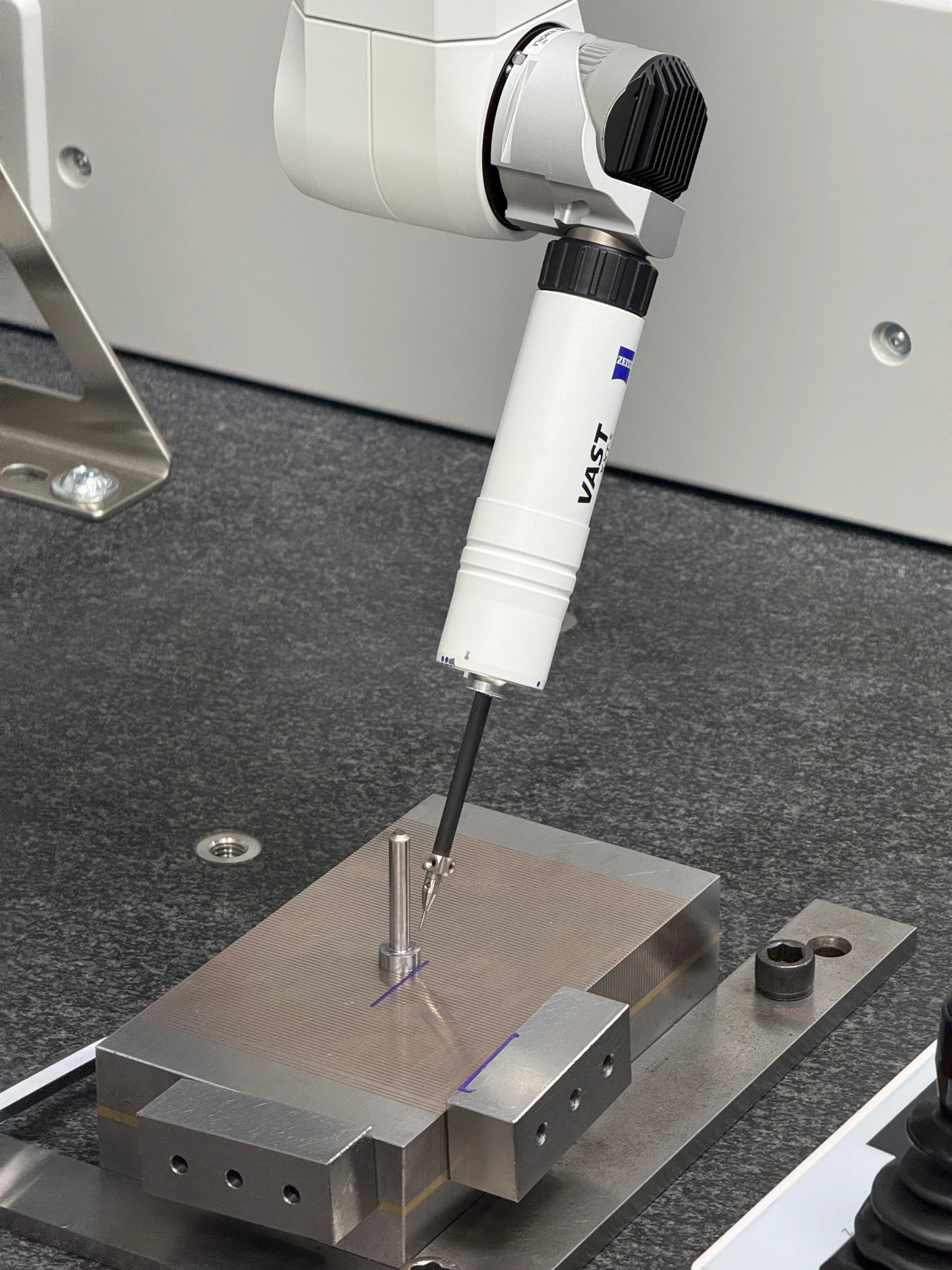 Library photograph of a coordinate measurement probe beside a slender metal component