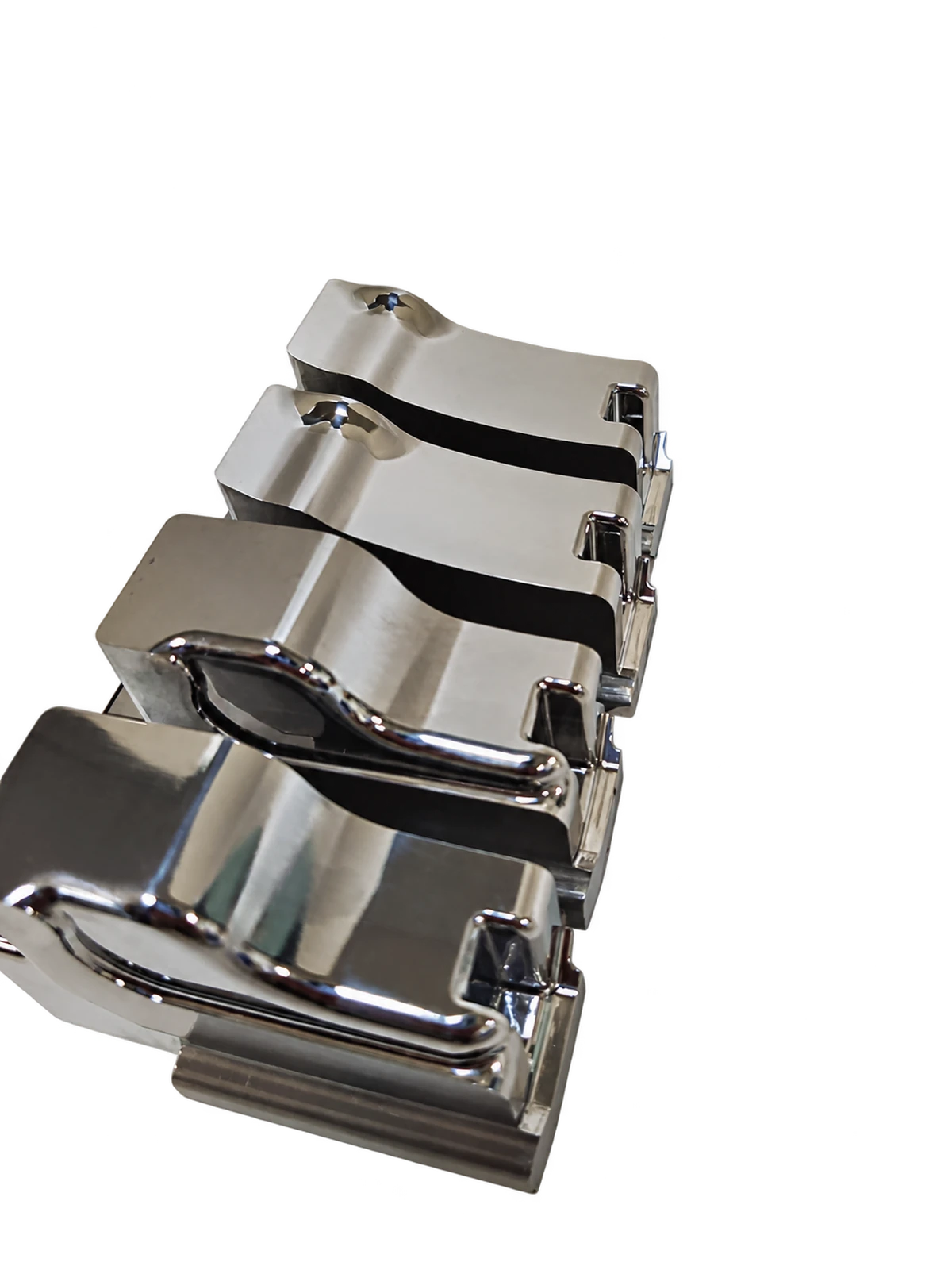 Background-removed display from source photograph: Metal components with repeated curved profiles and stepped edges