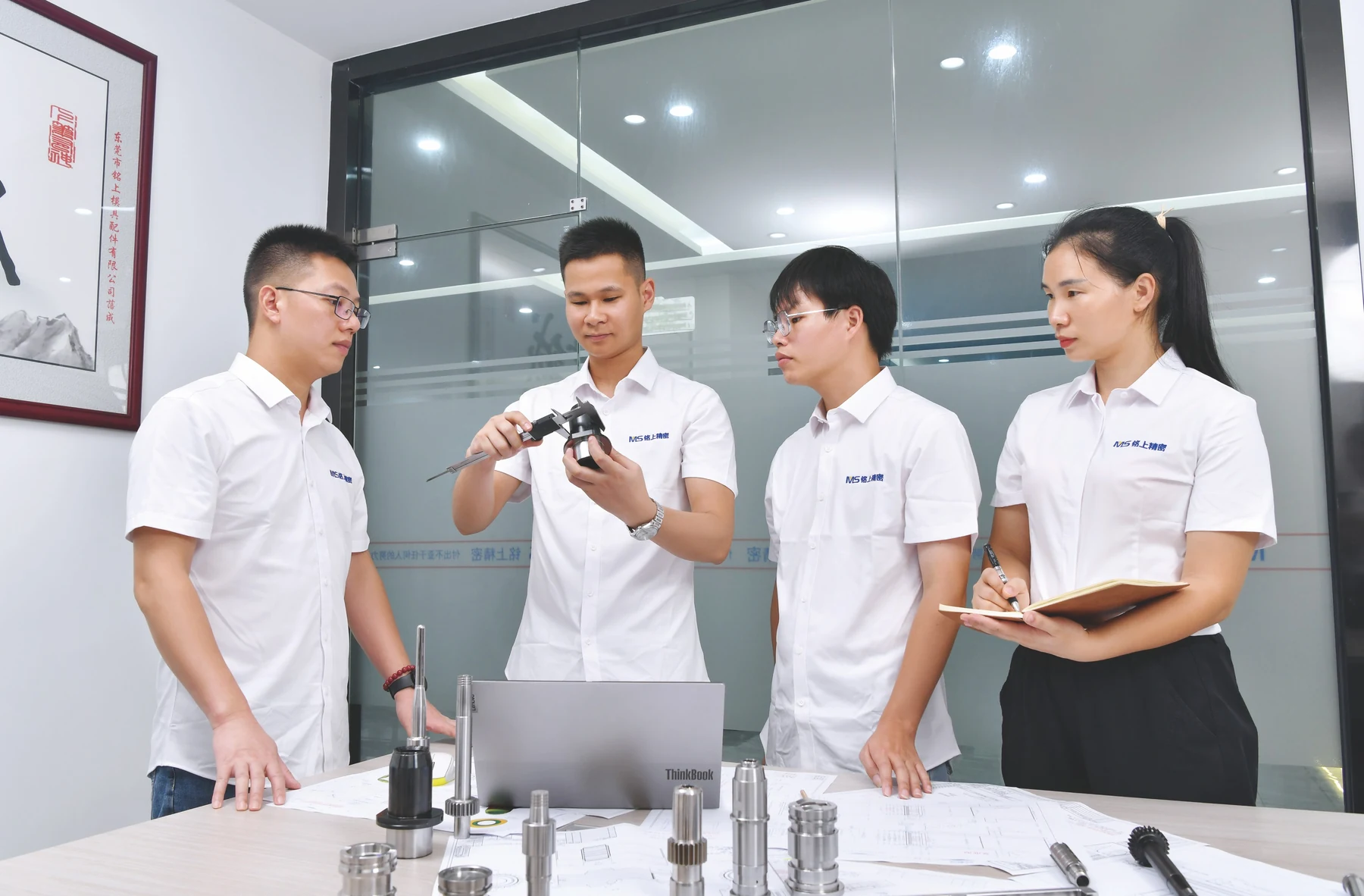 Colleagues discussing a technical component