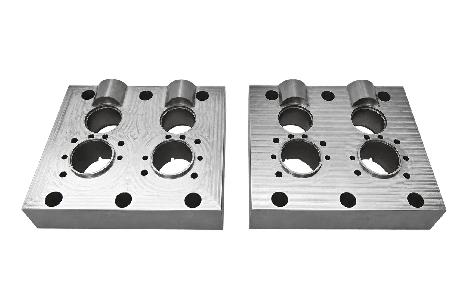 A pair of rectangular mold inserts with circular bores and patterned machining marks — AI-assisted transparent display version