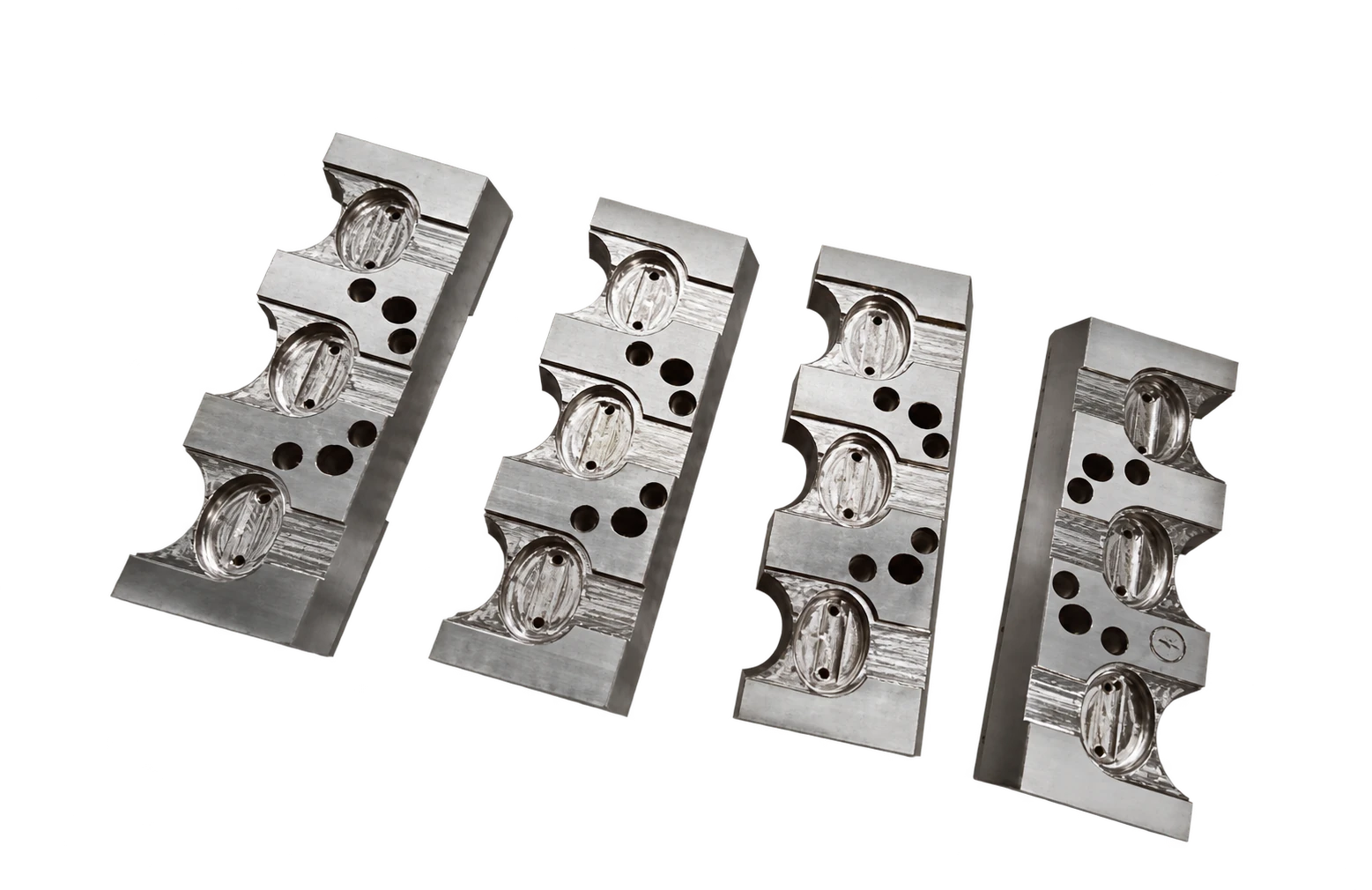 Four steel inserts with repeated curved forming profiles and holes — AI-assisted transparent display version